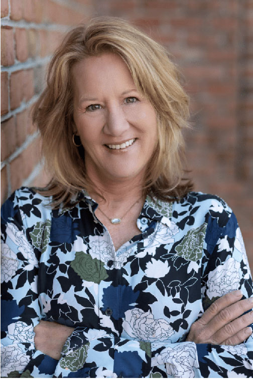 A happy lady in a blue floral top