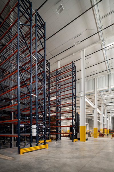 A warehouse with tall empty shelves